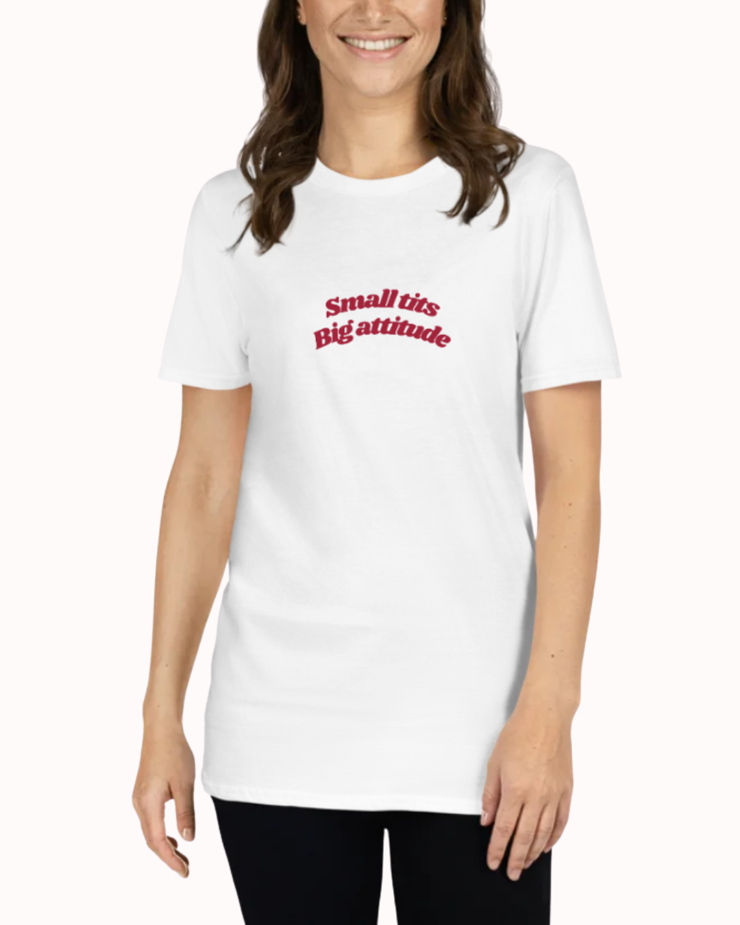 Front view of a White t-shirt worn by a smiling woman, featuring the phrase "Small tits. Big attitude" on the chest and back. Perfect for fans of funny merchandise, bold humor, and witty sarcasm.