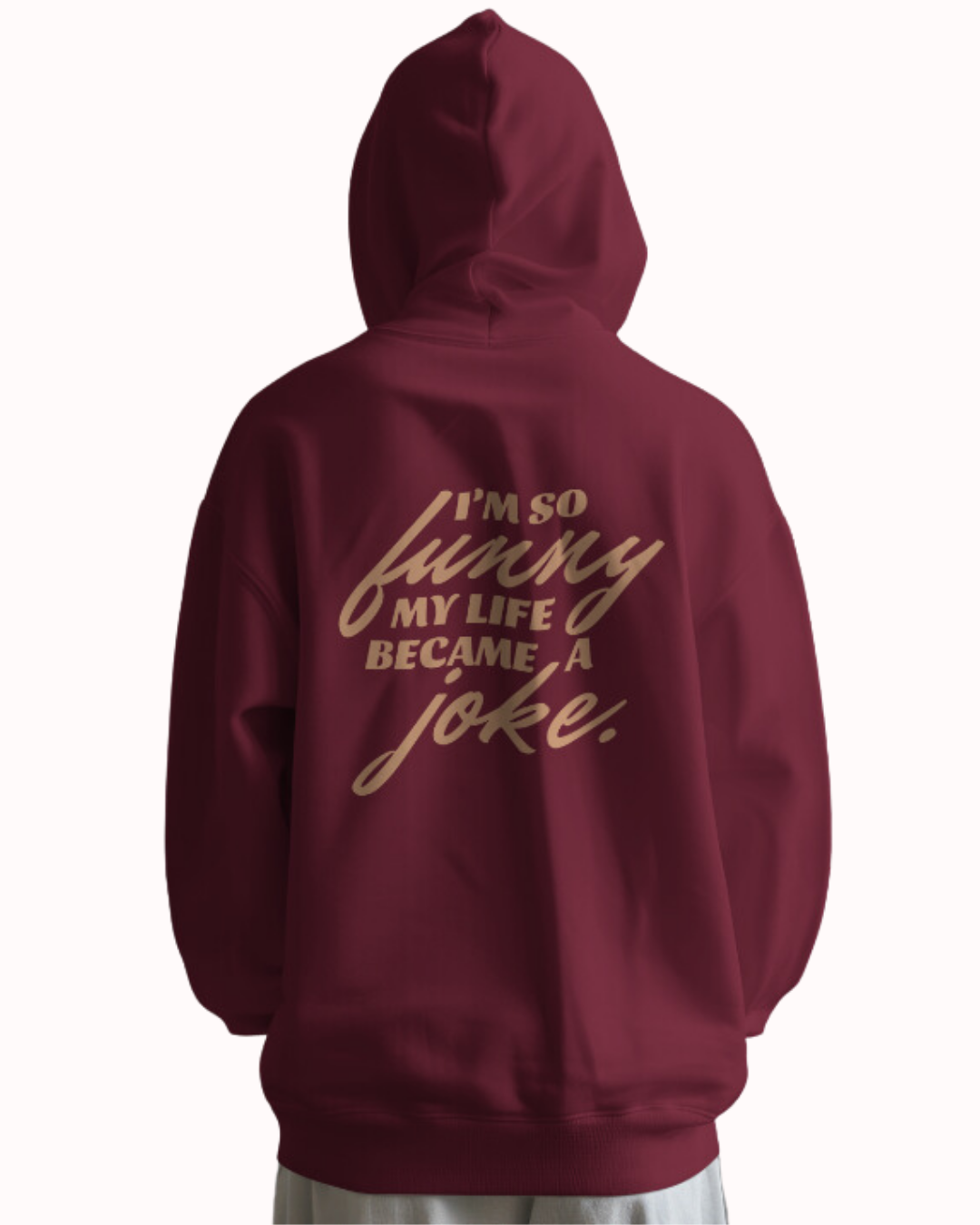 Back view of a maroon hoodie featuring the phrase 'I'm so funny my life became a joke' on the back. Perfect for fans of funny merchandise, bold humor, and witty sarcasm.