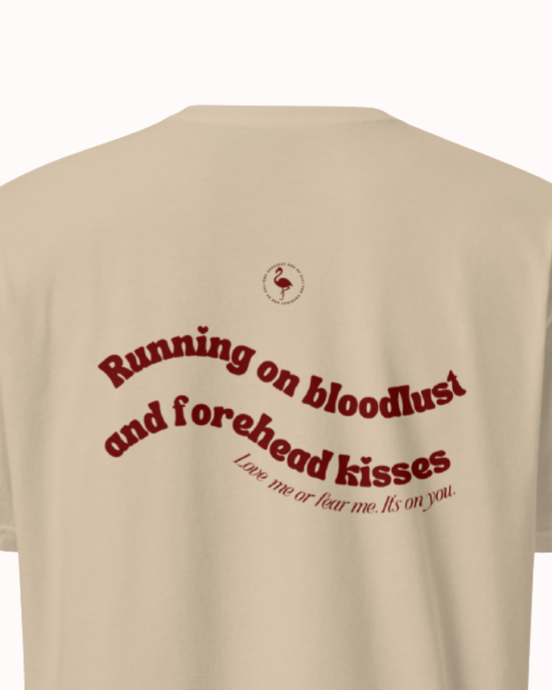Back view of a Sand t-shirt featuring the phrase "Running on bloodlust and forehead kisses" on the back. Perfect for fans of funny merchandise, bold humor, and witty sarcasm.