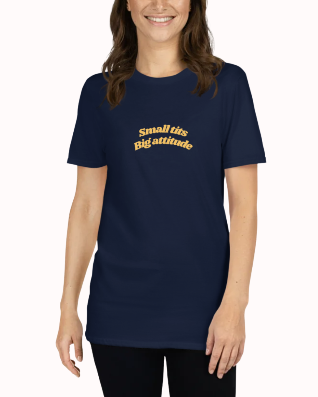 Front view of a Navy t-shirt worn by a smiling woman, featuring the phrase "Small tits. Big attitude" on the chest and back. Perfect for fans of funny merchandise, bold humor, and witty sarcasm.