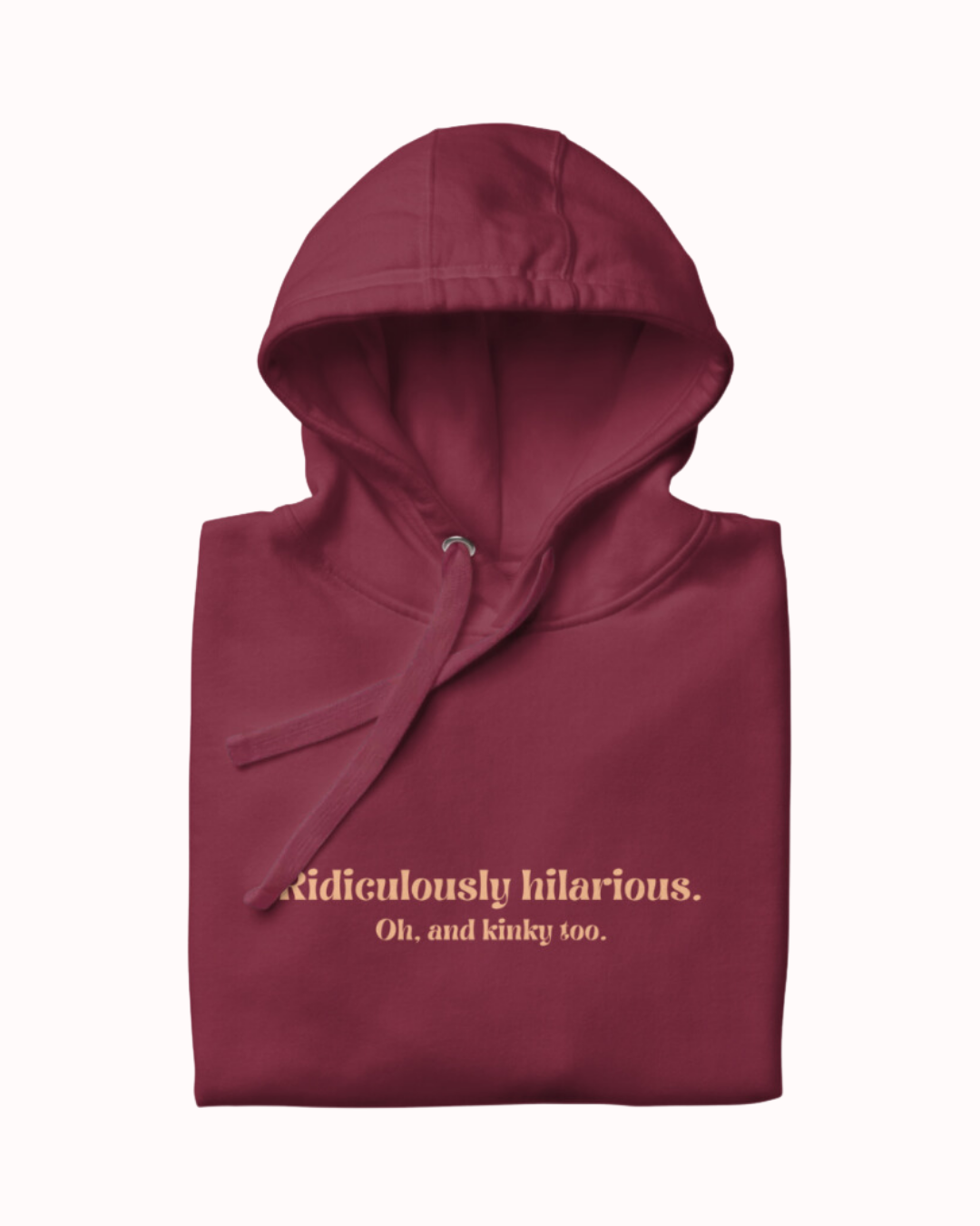 Folded maroon hoodie featuring the ironic phrase 'Ridiculously hilarious. Oh, and kinky too'. Perfect for fans of funny merchandise, bold humor, and witty sarcasm.