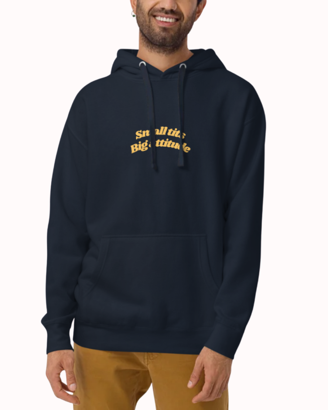 Front view of a Navy Blazer hoodie worn by a smiling man, featuring the phrase "Small tits. Big attitude" on the chest and back. Perfect for fans of funny merchandise, bold humor, and witty sarcasm.