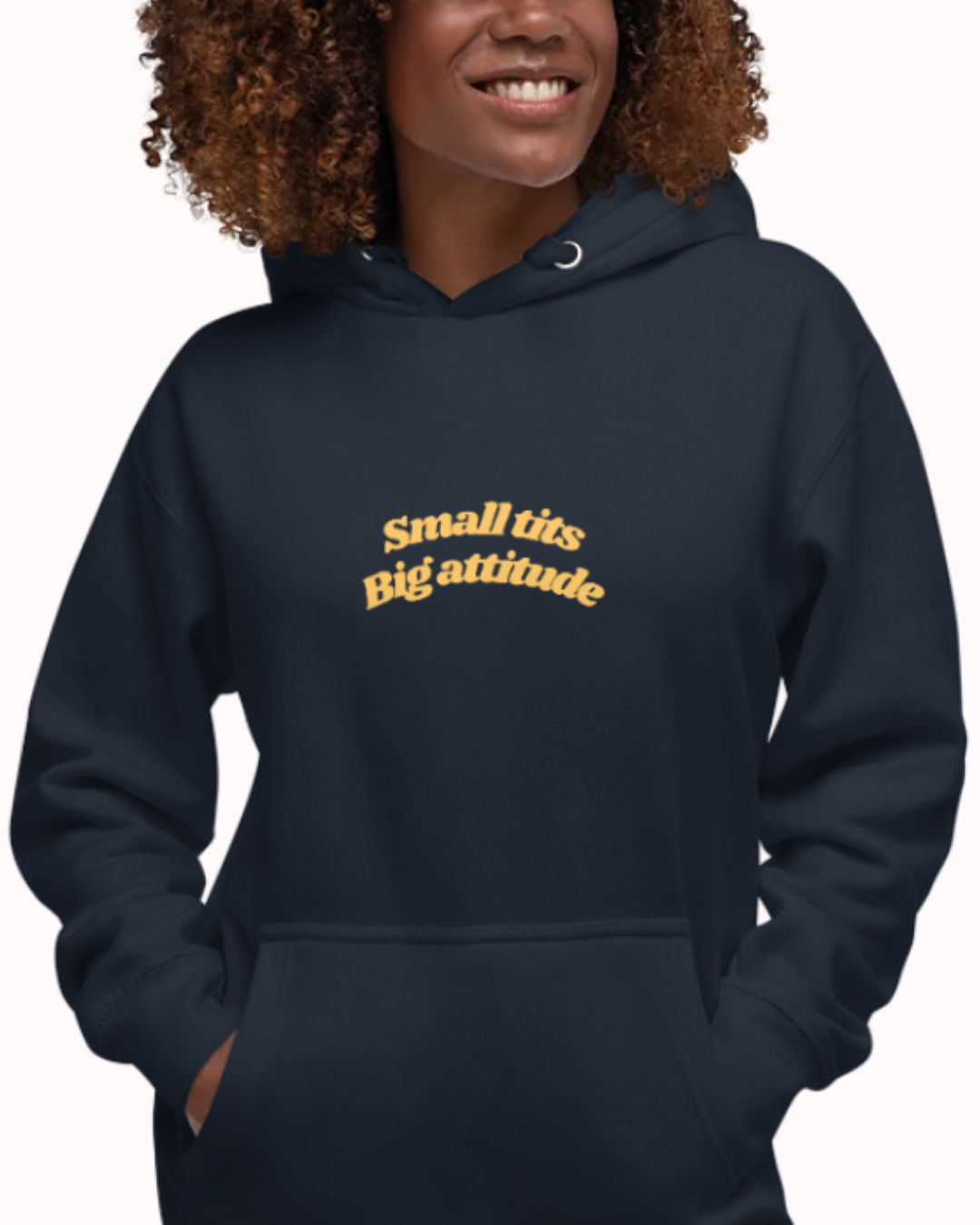 Front view of a Navy Blazer hoodie worn by a smiling woman, featuring the phrase "Small tits. Big attitude" on the chest and back. Perfect for fans of funny merchandise, bold humor, and witty sarcasm.