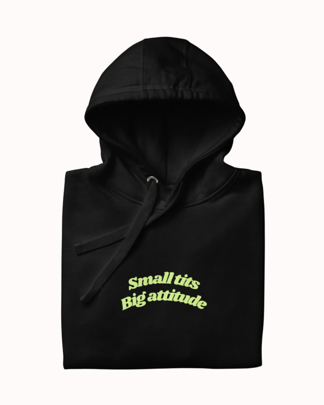 Folded Black hoodie featuring the ironic phrase "Small tits. Big attitude". Perfect for fans of funny merchandise, bold humor, and witty sarcasm.