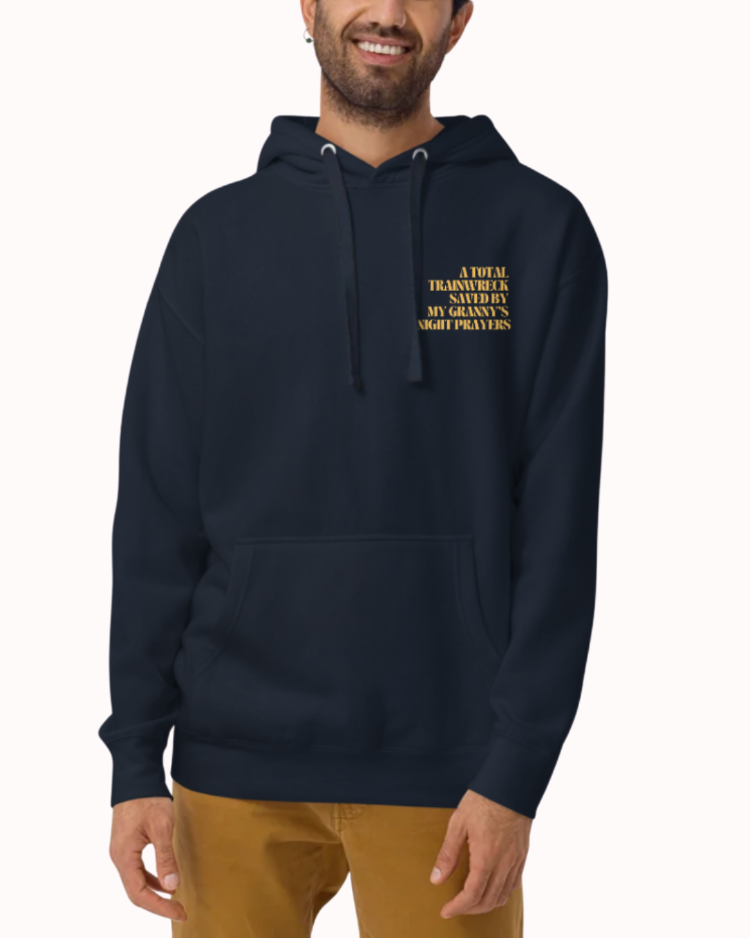 Front view of a Navy Blazer hoodie worn by a smiling man, featuring the phrase "A total trainwreck saved my granny's night prayers" on the chest and back. Perfect for fans of funny merchandise, bold humor, and witty sarcasm.