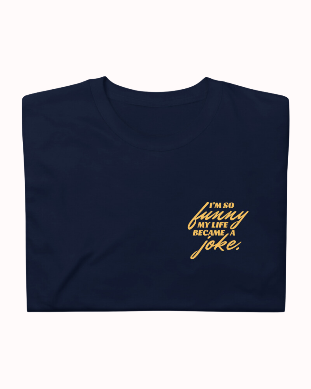 Folded navy T-Shirt featuring the ironic phrase 'I'm so funny my life became a joke'. Perfect for fans of funny merchandise, bold humor, and witty sarcasm.