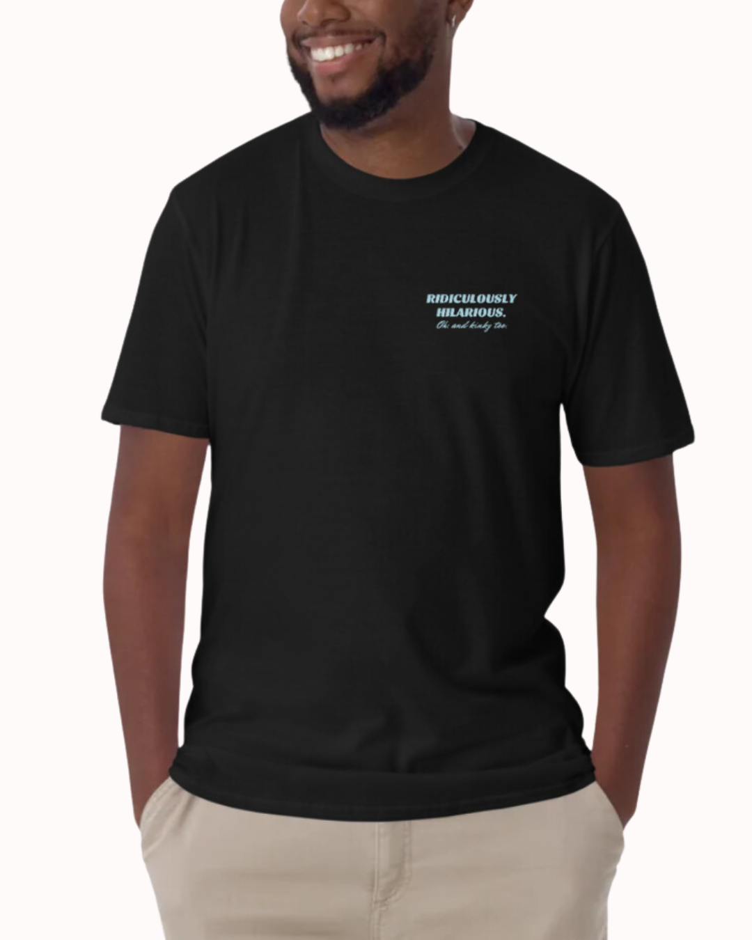 Front view of a black T-Shirt worn by a smiling man, featuring the phrase 'Ridiculously hilarious. Oh, and kinky too' on the chest and back. Perfect for fans of funny merchandise, bold humor, and witty sarcasm.