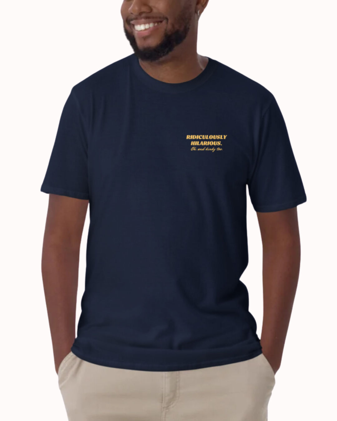 Front view of a navy T-Shirt worn by a smiling man, featuring the phrase 'Ridiculously hilarious. Oh, and kinky too' on the chest and back. Perfect for fans of funny merchandise, bold humor, and witty sarcasm.