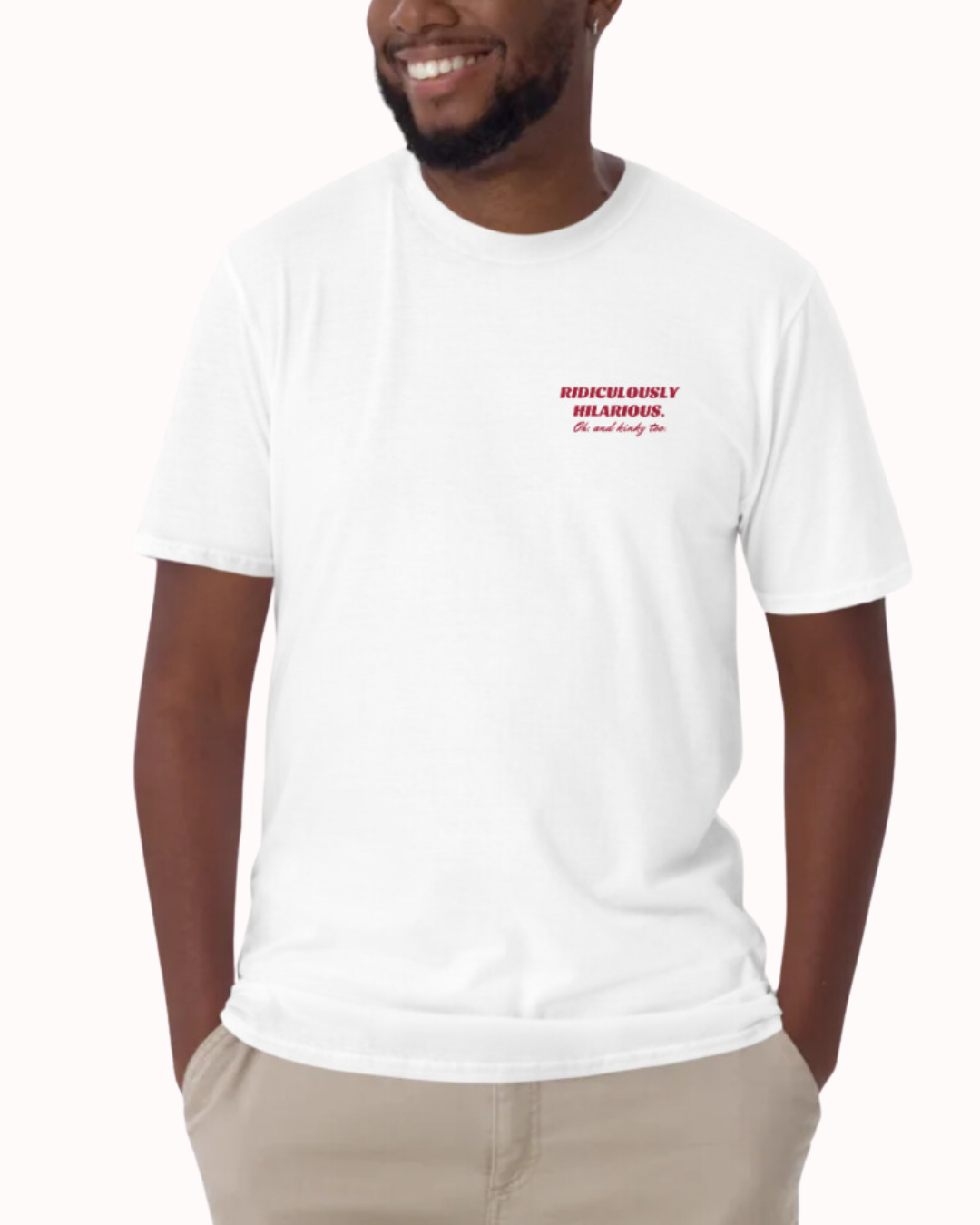 Front view of a white T-Shirt worn by a smiling man, featuring the phrase 'Ridiculously hilarious. Oh, and kinky too' on the chest and back. Perfect for fans of funny merchandise, bold humor, and witty sarcasm.