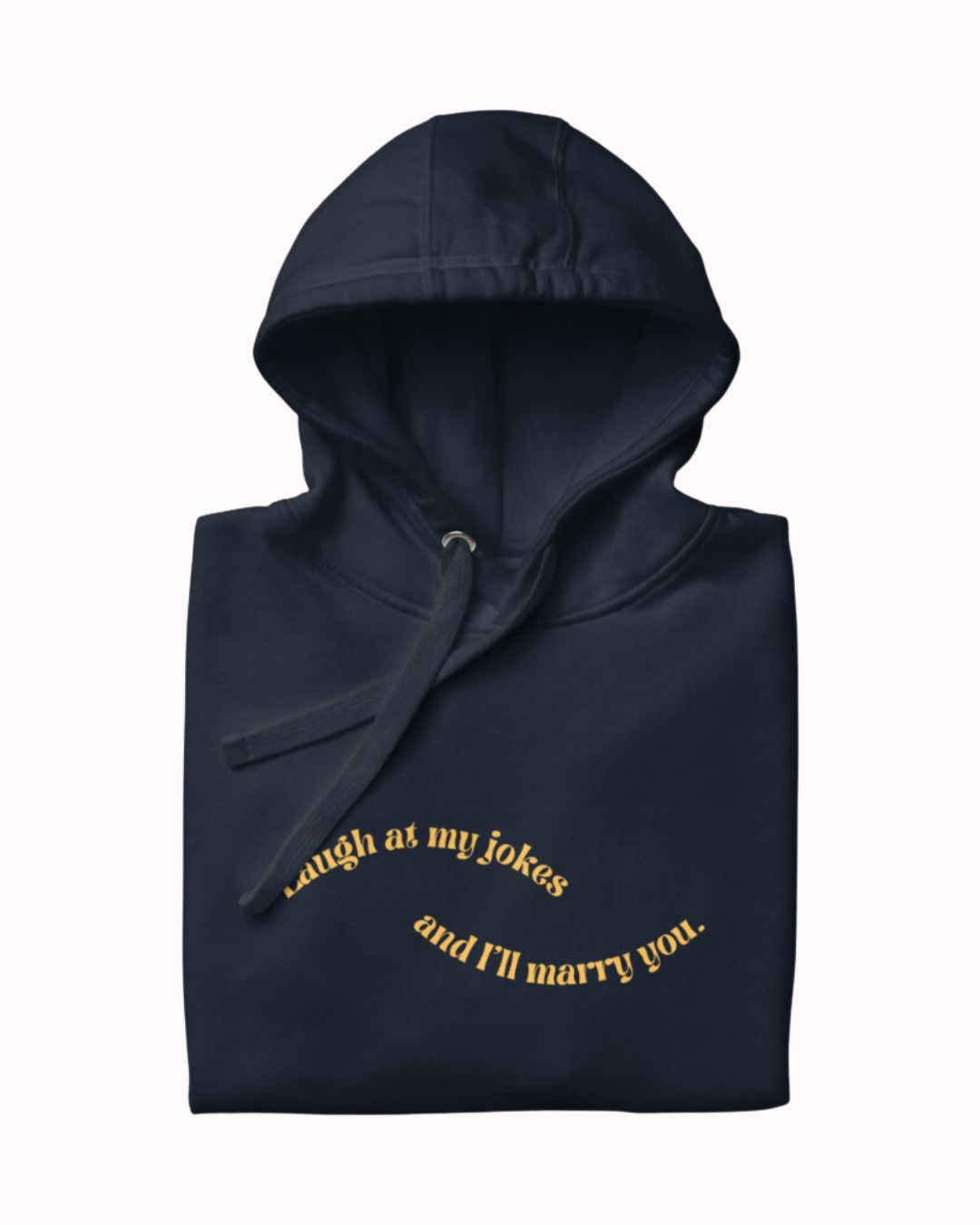 Folded navy blazer hoodie featuring the ironic phrase 'Laugh at my jokes and I'll marry you'. Perfect for fans of funny merchandise, bold humor, and witty sarcasm.