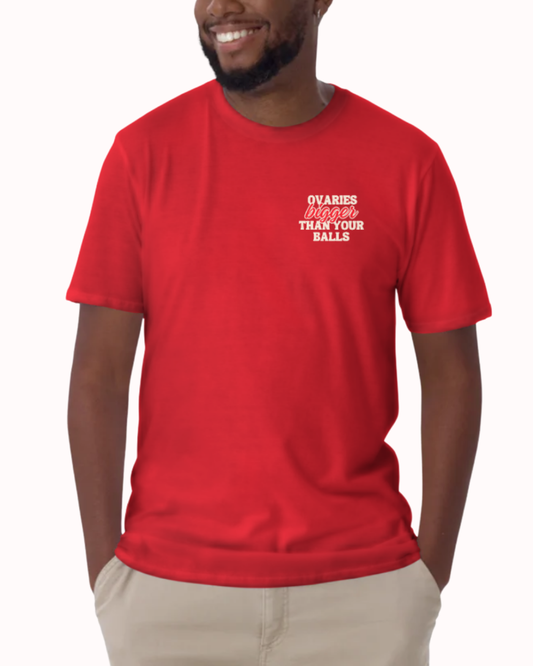 Front view of a Red t-shirt worn by a smiling man, featuring the phrase "Ovaries bigger than your balls" on the chest and back. Perfect for fans of funny merchandise, bold humor, and witty sarcasm.