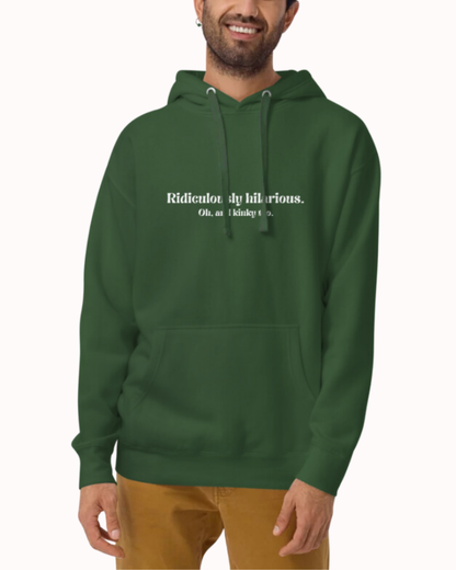 Front view of a forest green hoodie worn by a smiling man, featuring the phrase 'Ridiculously hilarious. Oh, and kinky too' on the chest. Perfect for fans of funny merchandise, bold humor, and witty sarcasm.