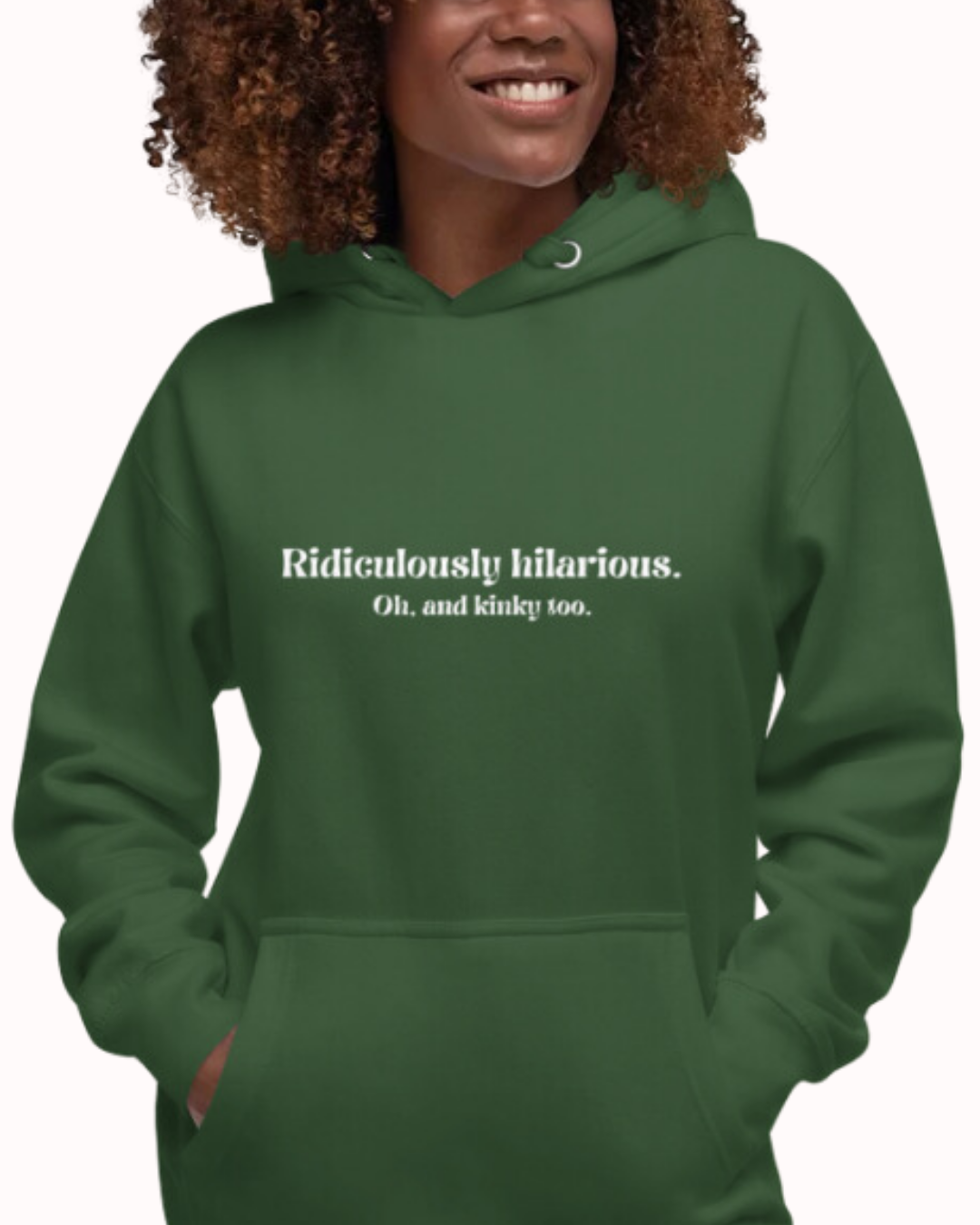 Front view of a forest green hoodie worn by a smiling woman, featuring the phrase 'Ridiculously hilarious. Oh, and kinky too' on the chest. Perfect for fans of funny merchandise, bold humor, and witty sarcasm.