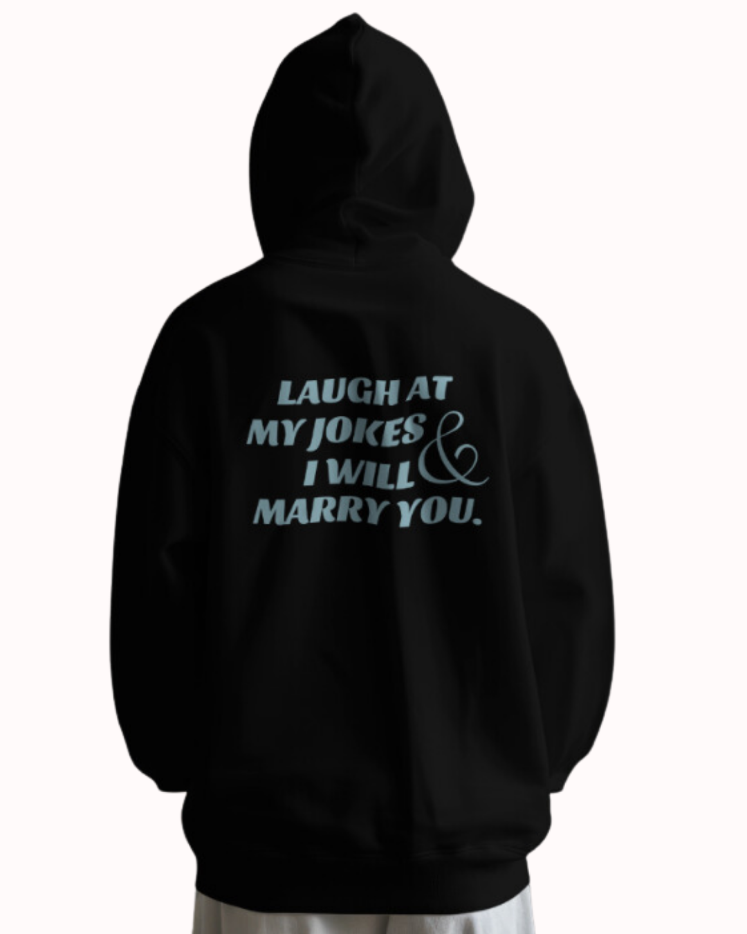 Back view of a black hoodie featuring the phrase 'Laugh at my jokes and I will marry you' on the back. Perfect for fans of funny merchandise, bold humor, and witty sarcasm.