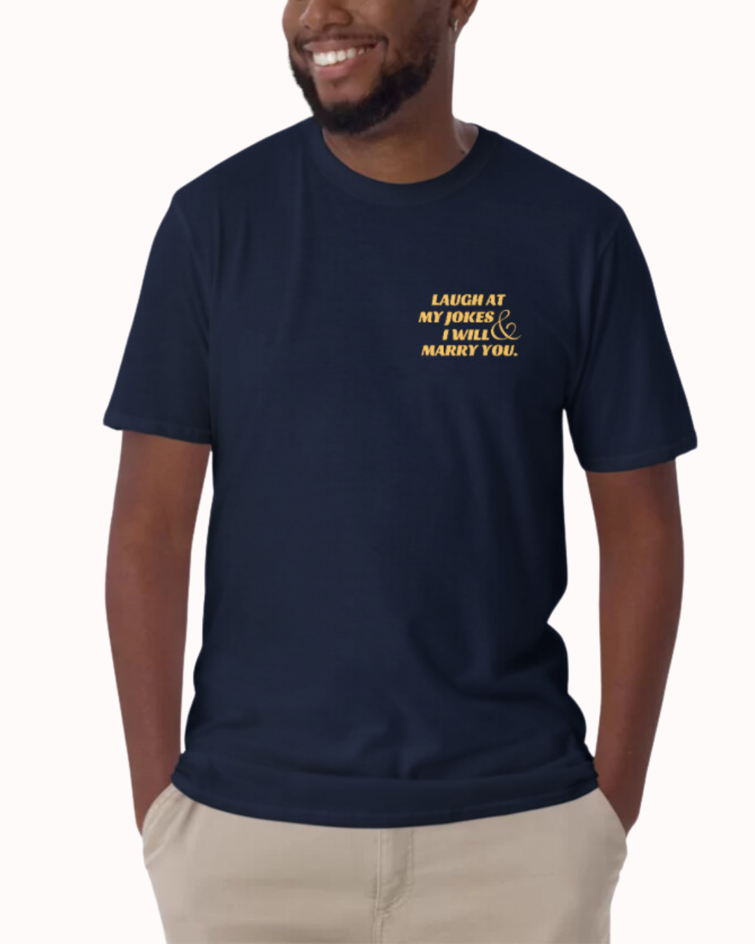 Front view of a navy T-Shirt worn by a smiling man, featuring the phrase 'Laugh at my jokes and I will marry you'' on the chest and back. Perfect for fans of funny merchandise, bold humor, and witty sarcasm. 