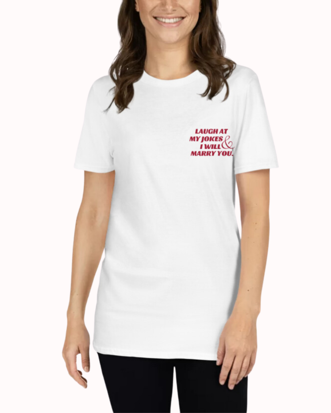 Front view of a white T-Shirt worn by a smiling woman, featuring the phrase 'Laugh at my jokes and I will marry you' on the chest and back. Perfect for fans of funny merchandise, bold humor, and witty sarcasm.