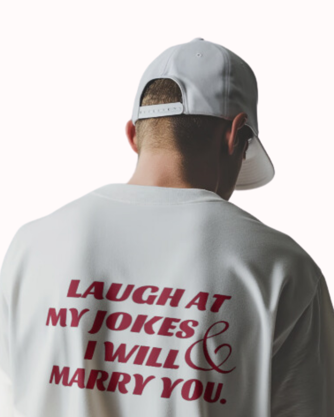 Back view of a white T-Shirt featuring the phrase 'Laugh at my jokes and I will marry you' on the back. Perfect for fans of funny merchandise, bold humor, and witty sarcasm.