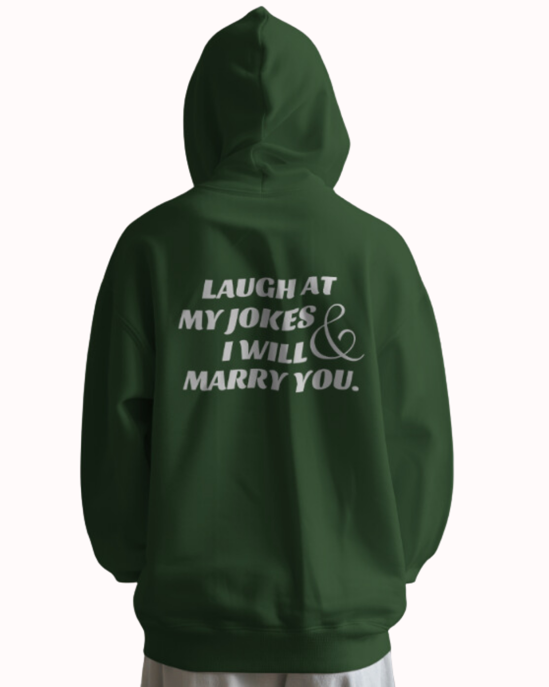 Back view of a forest green hoodie featuring the phrase 'Laugh at my jokes and I will marry you' on the back. Perfect for fans of funny merchandise, bold humor, and witty sarcasm.