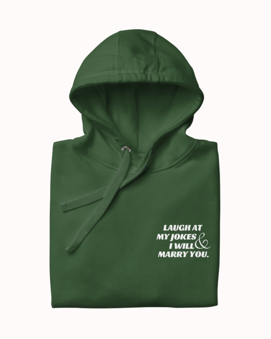 Folded forest green hoodie featuring the ironic phrase 'Laugh at my jokes and I will marry you'. Perfect for fans of funny merchandise, bold humor, and witty sarcasm.