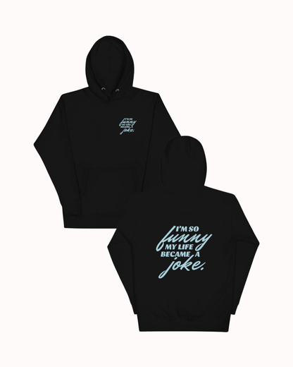 Front and back view of a black hoodie featuring the phrase 'I'm so funny my life became a joke' on the back. Perfect for fans of funny merchandise, bold humor, and witty sarcasm.