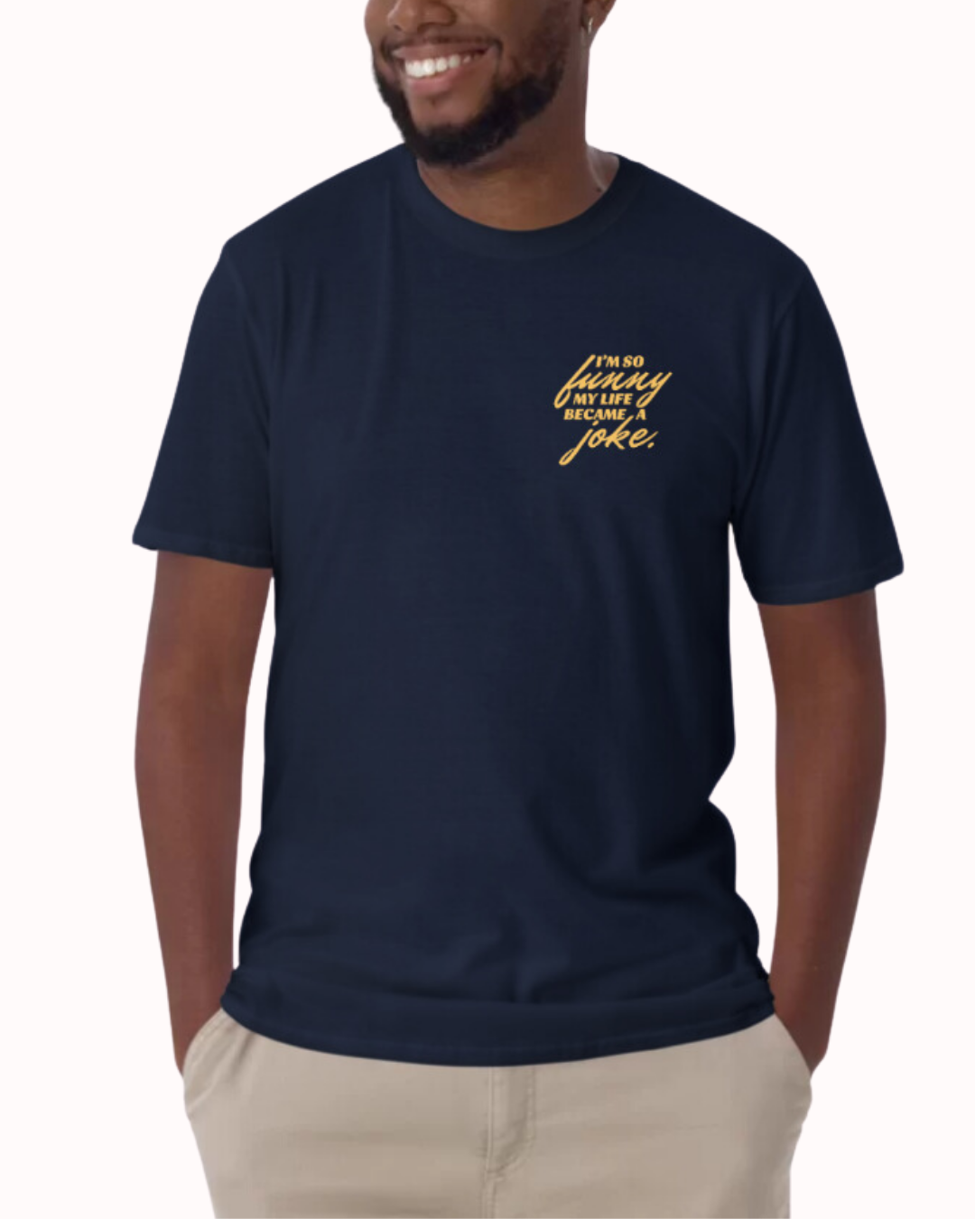 Front view of a navy T-Shirt worn by a smiling man, featuring the phrase 'I'm so funny my life became a joke' on the chest and back. Perfect for fans of funny merchandise, bold humor, and witty sarcasm. 