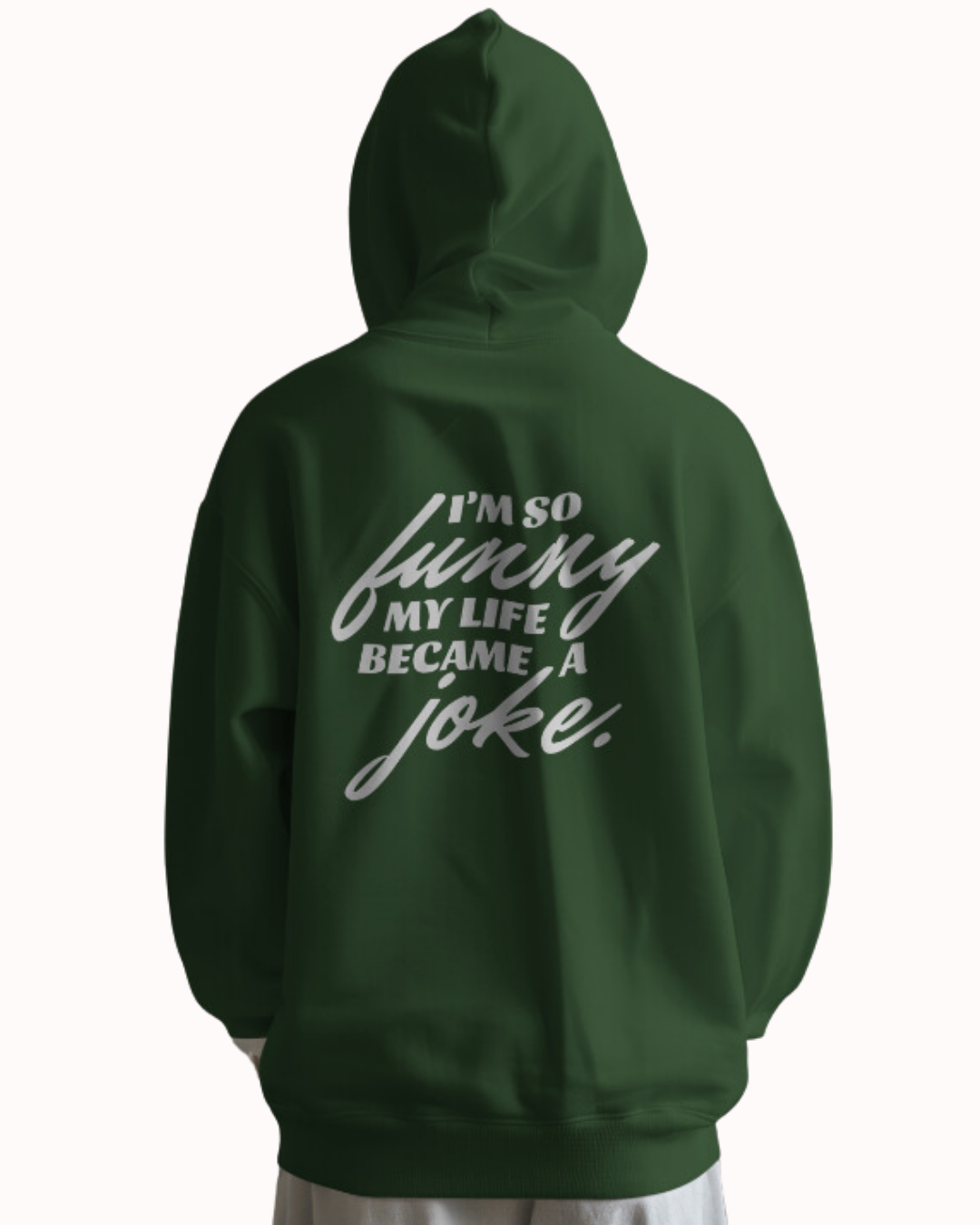 Back view of a forest green hoodie featuring the phrase 'I'm so funny my life became a joke' on the back. Perfect for fans of funny merchandise, bold humor, and witty sarcasm.