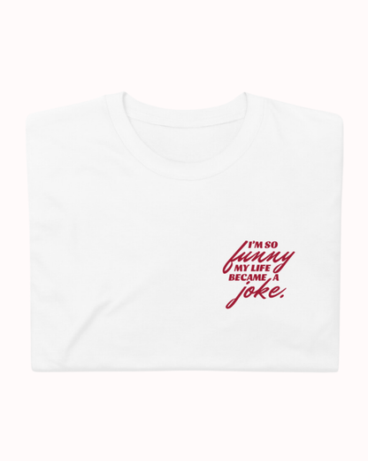 Folded white T-Shirt featuring the ironic phrase 'I'm so funny my life became a joke'. Perfect for fans of funny merchandise, bold humor, and witty sarcasm. 