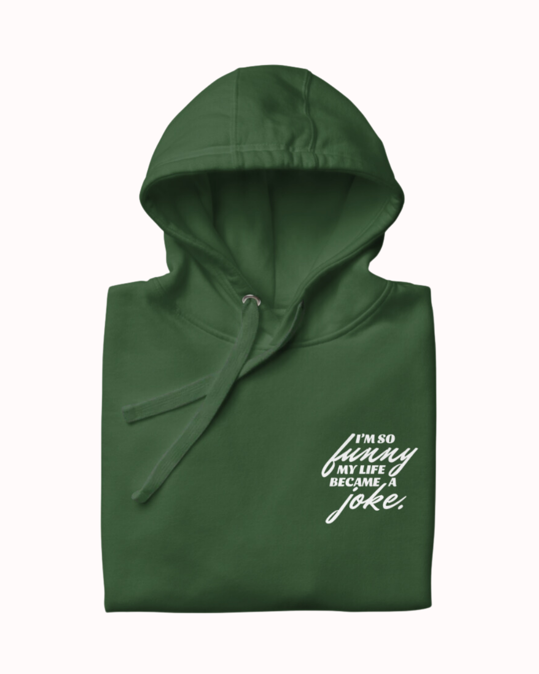 Folded forest green hoodie featuring the ironic phrase 'I'm so funny my life became a joke'. Perfect for fans of funny merchandise, bold humor, and witty sarcasm.