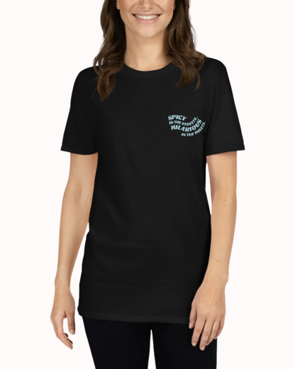 Front view of a black T-Shirt worn by a smiling woman, featuring the phrase 'Spicy in the streets, Hilarious in the sheets' on the chest and back. Perfect for fans of funny merchandise, bold humor, and witty sarcasm.