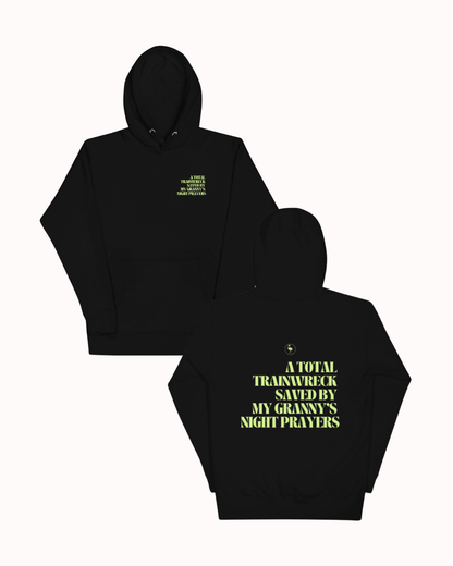 Front and back view of a Black hoodie featuring the phrase "A total trainwreck saved my granny's night prayers" on the back. Perfect for fans of funny merchandise, bold humor, and witty sarcasm.