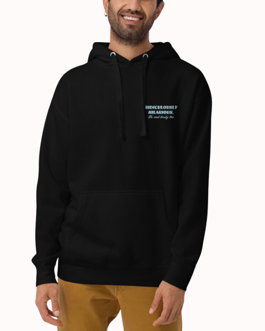 Front view of a black hoodie worn by a smiling man, featuring the phrase 'Ridiculously hilarious. Oh, and kinky too' on the chest and back. Perfect for fans of funny merchandise, bold humor, and witty sarcasm.
