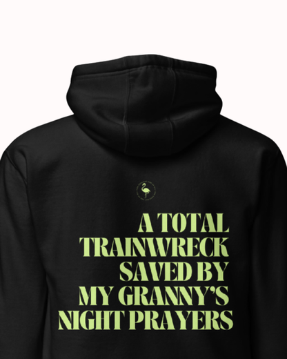 Back view of a Black hoodie featuring the phrase "A total trainwreck saved my granny's night prayers" on the back. Perfect for fans of funny merchandise, bold humor, and witty sarcasm.
