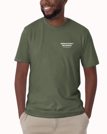 Front view of a military green T-Shirt worn by a smiling man, featuring the phrase 'Ridiculously hilarious. Oh, and kinky too'  on the chest and back. Perfect for fans of funny merchandise, bold humor, and witty sarcasm. 