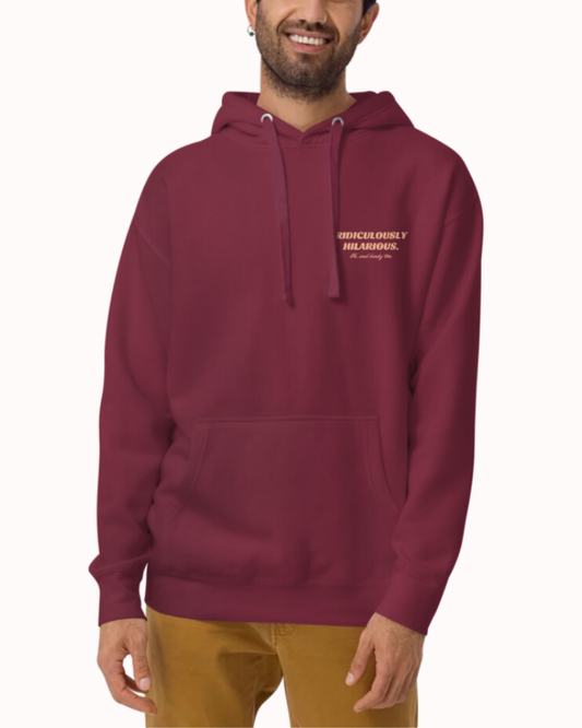 Front view of a maroon hoodie worn by a smiling man, featuring the phrase 'Ridiculously hilarious. Oh, and kinky too' on the chest and back. Perfect for fans of funny merchandise, bold humor, and witty sarcasm. 