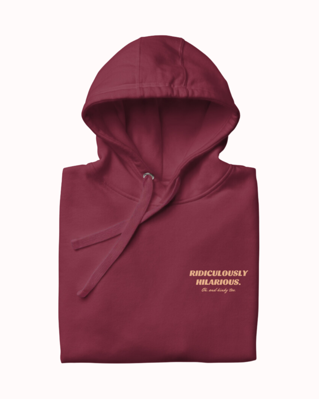 Folded maroon hoodie featuring the ironic phrase 'Ridiculously hilarious. Oh, and kinky too'. Perfect for fans of funny merchandise, bold humor, and witty sarcasm. 