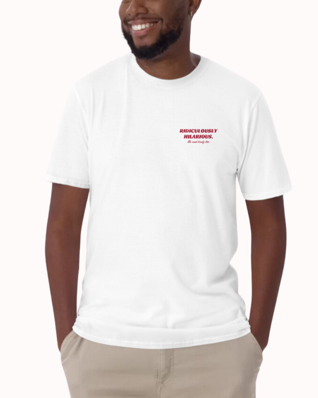 Front view of a white T-Shirt worn by a smiling man, featuring the phrase 'Ridiculously hilarious. Oh, and kinky too' on the chest and back. Perfect for fans of funny merchandise, bold humor, and witty sarcasm. 