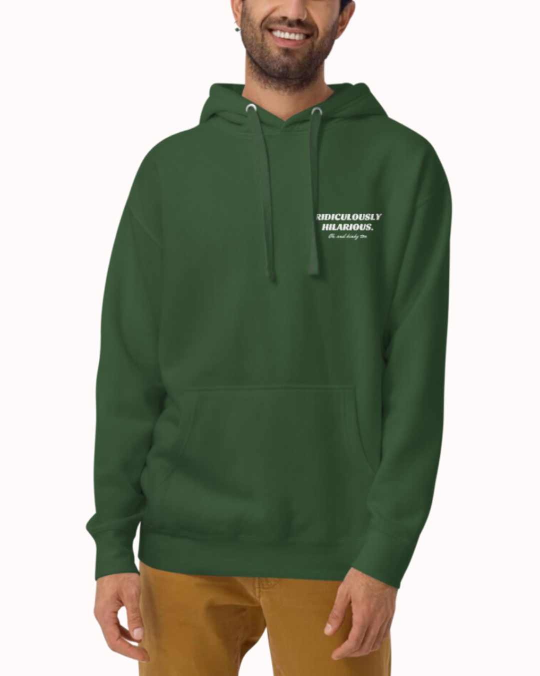 Front view of a forest green hoodie worn by a smiling man, featuring the phrase 'Ridiculously hilarious. Oh, and kinky too' on the chest and back. Perfect for fans of funny merchandise, bold humor, and witty sarcasm.