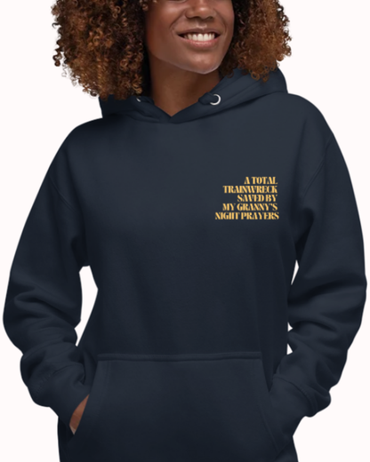 Front view of a Navy Blazer hoodie worn by a smiling woman, featuring the phrase "A total trainwreck saved my granny's night prayers" on the chest and back. Perfect for fans of funny merchandise, bold humor, and witty sarcasm.