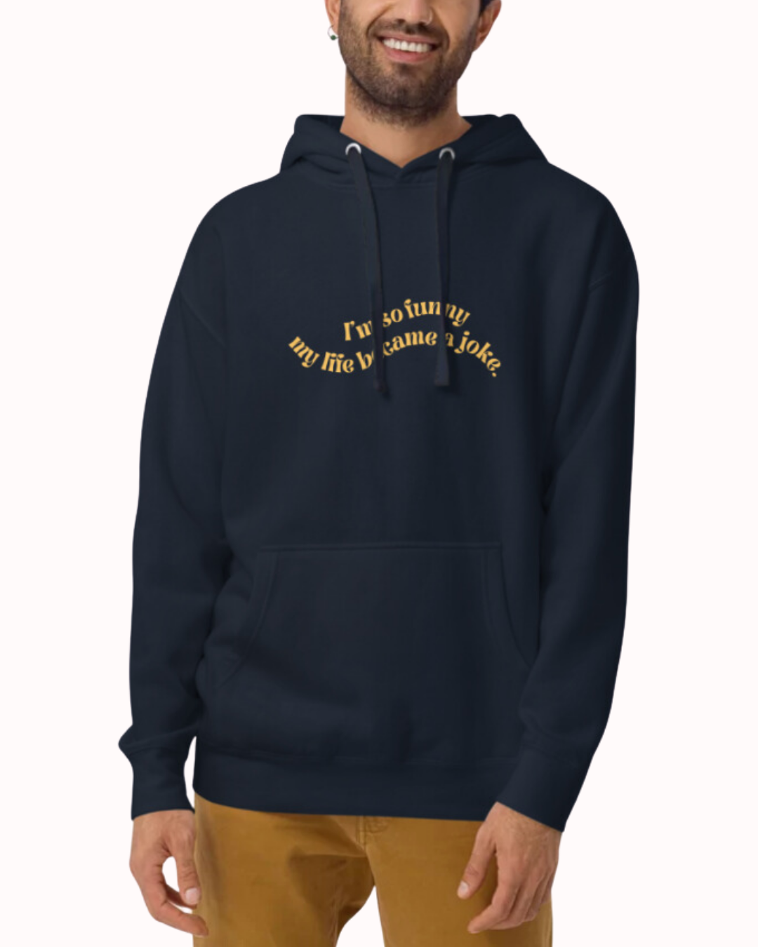 Front view of a navy blazer hoodie worn by a smiling man, featuring the phrase 'I'm so funny my life became a joke' on the chest. Perfect for fans of funny merchandise, bold humor, and witty sarcasm.