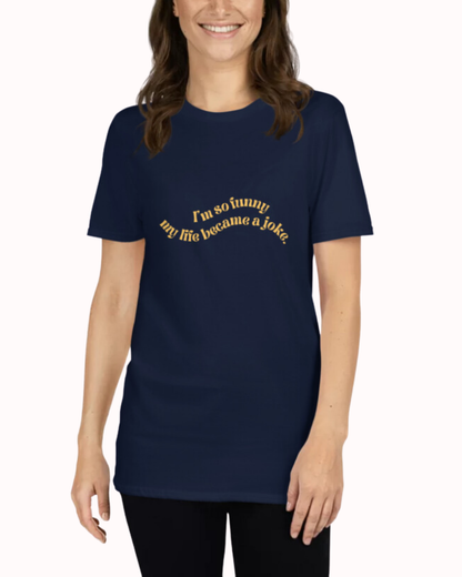 Front view of a navy T-Shirt worn by a smiling woman, featuring the phrase 'I'm so funny my life became a joke' on the chest. Perfect for fans of funny merchandise, bold humor, and witty sarcasm.