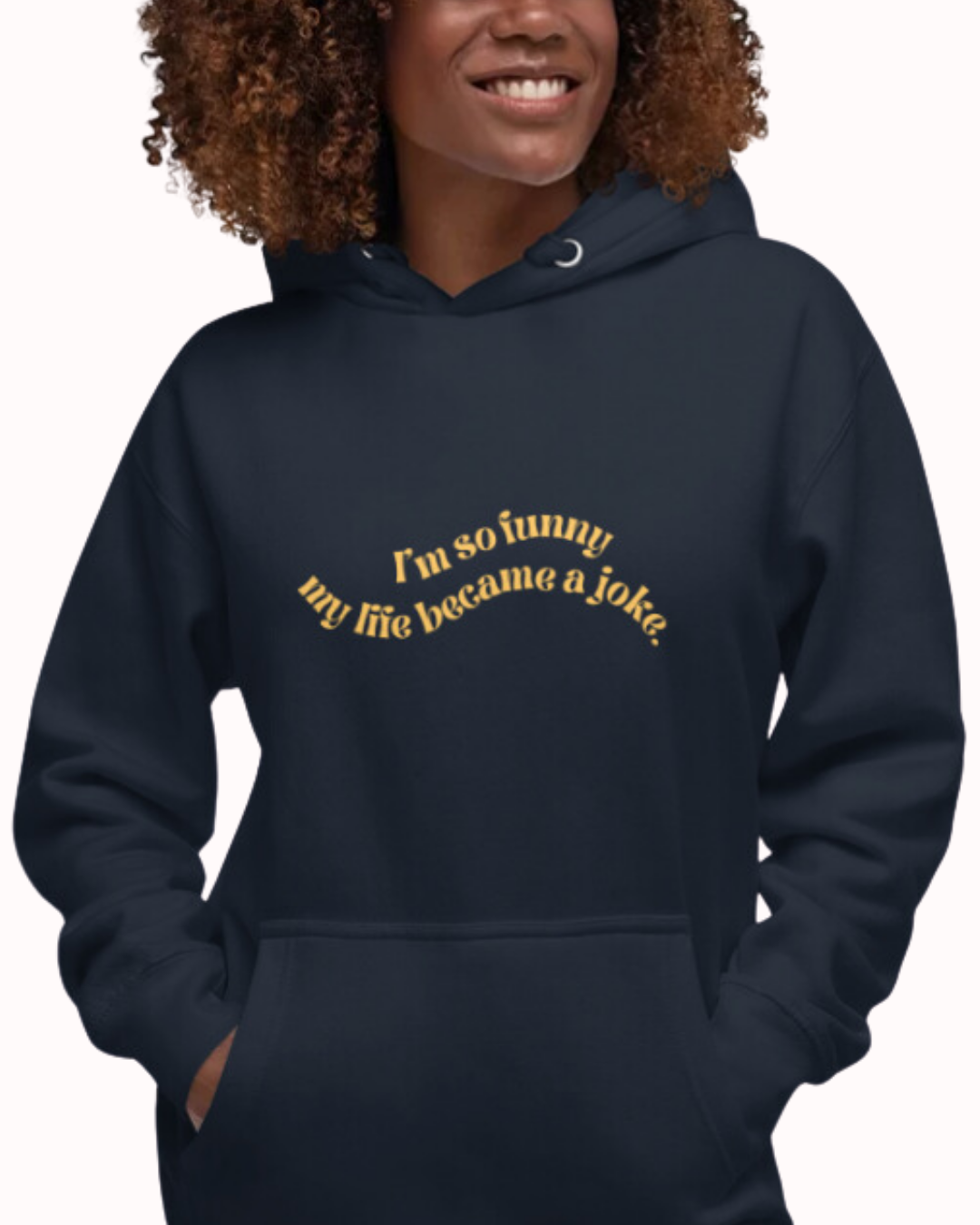 Front view of a navy blazer hoodie worn by a smiling woman, featuring the phrase 'I'm so funny my life became a joke' on the chest. Perfect for fans of funny merchandise, bold humor, and witty sarcasm.