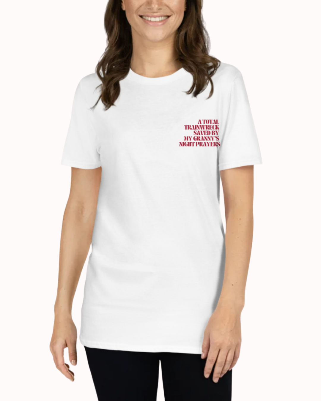 Front view of a White t-shirt worn by a smiling woman, featuring the phrase "A total trainwreck saved my granny's night prayers" on the chest and back. Perfect for fans of funny merchandise, bold humor, and witty sarcasm.