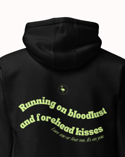 Back view of a Black hoodie featuring the phrase "Running on bloodlust and forehead kisses" on the back. Perfect for fans of funny merchandise, bold humor, and witty sarcasm.
