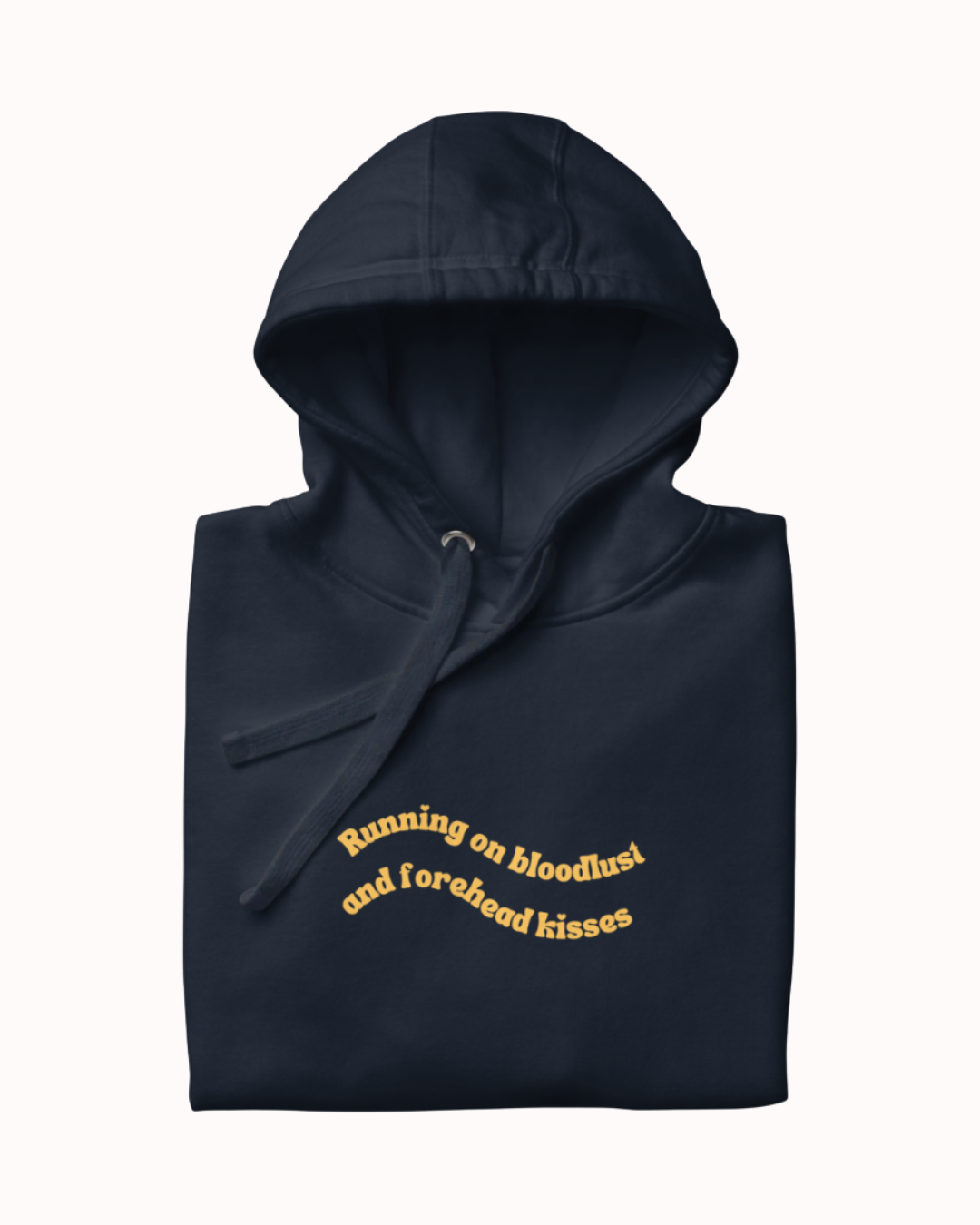 Folded Navy Blazer hoodie featuring the ironic phrase "Running on bloodlust and forehead kisses". Perfect for fans of funny merchandise, bold humor, and witty sarcasm.