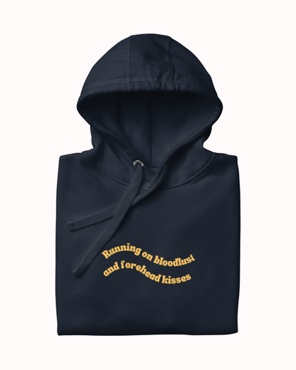 Folded Navy Blazer hoodie featuring the ironic phrase "Running on bloodlust and forehead kisses". Perfect for fans of funny merchandise, bold humor, and witty sarcasm.