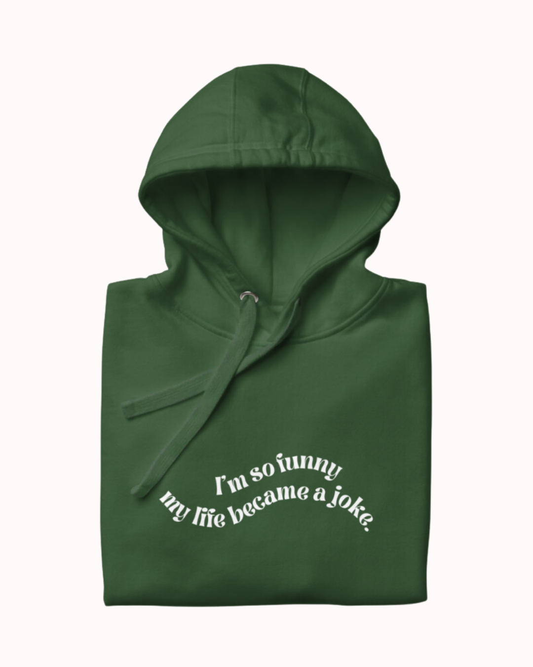 
Folded forest green hoodie featuring the ironic phrase 'I'm so funny my life became a joke'. Perfect for fans of funny merchandise, bold humor, and witty sarcasm.