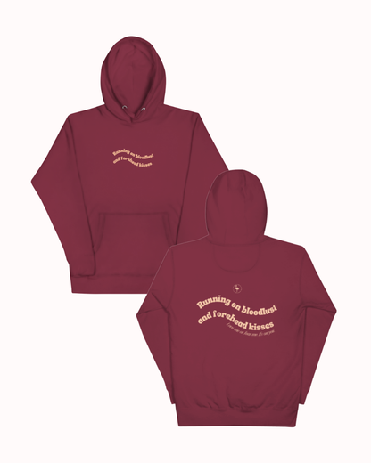 Front and back view of a Maroon hoodie featuring the phrase "Running on bloodlust and forehead kisses" on the back. Perfect for fans of funny merchandise, bold humor, and witty sarcasm.