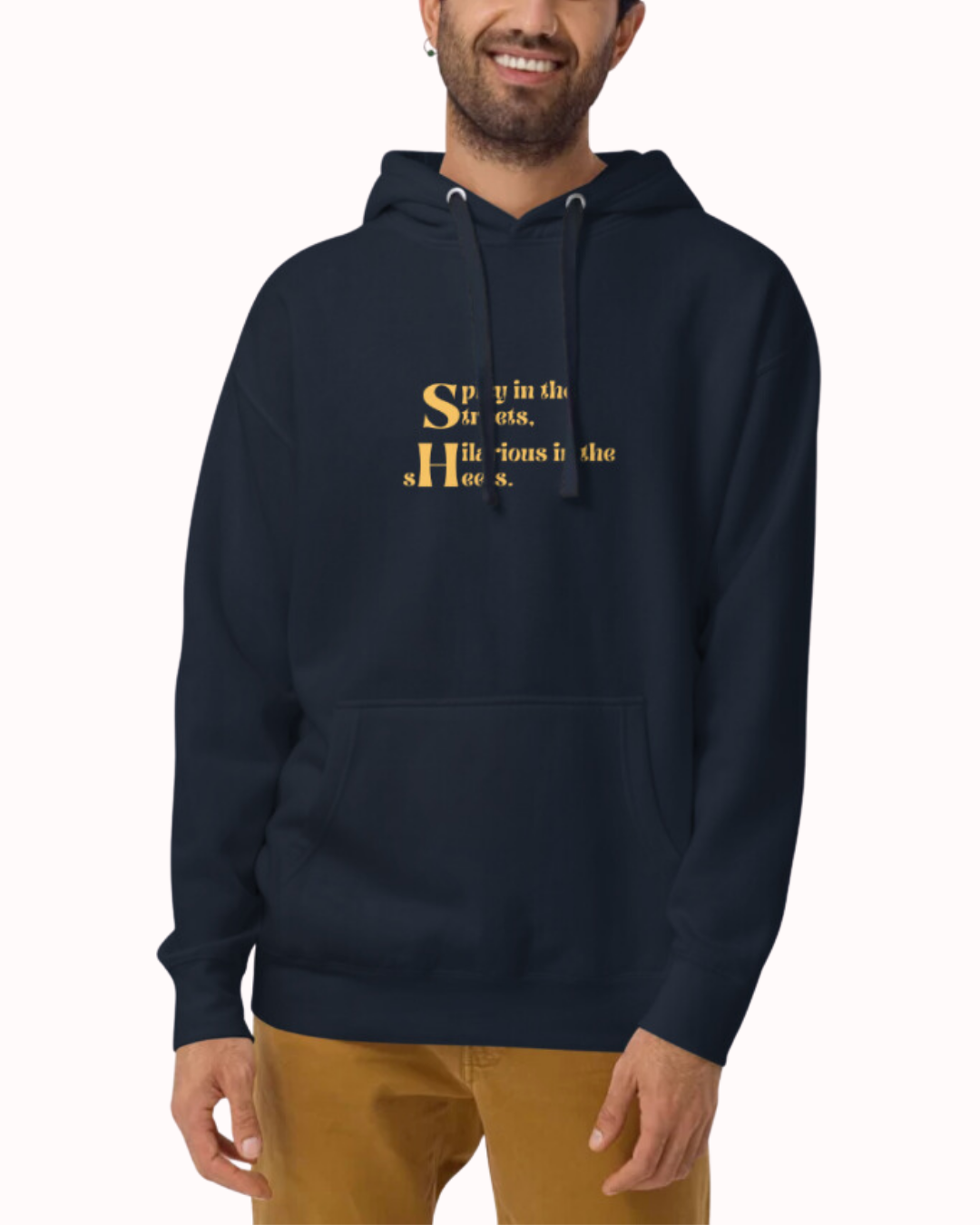 Front view of a navy blazer hoodie worn by a smiling man, featuring the phrase 'Spicy in the streets, Hilarious in the sheets' on the chest. Perfect for fans of funny merchandise, bold humor, and witty sarcasm.