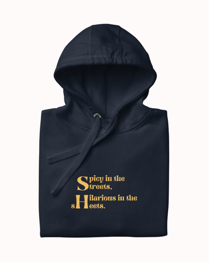 Folded navy blazer hoodie featuring the ironic phrase 'Spicy in the streets, Hilarious in the sheets'. Perfect for fans of funny merchandise, bold humor, and witty sarcasm.