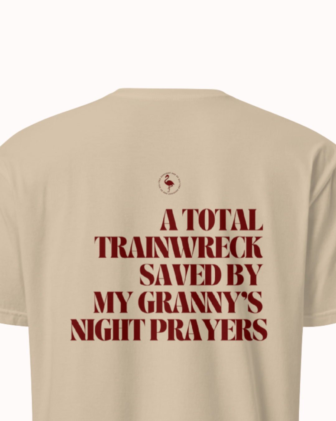 Back view of a Sand t-shirt featuring the phrase "A total trainwreck saved my granny's night prayers" on the back. Perfect for fans of funny merchandise, bold humor, and witty sarcasm.